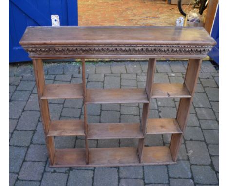 Wall shelf unit with carved pediment