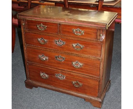 A George III mahogany bachelor's chest, the rectangular fold-over top above two short over three long drawers, on bracket fee