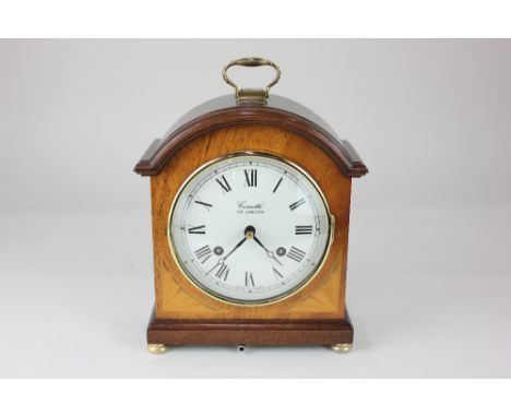 A Comitti of London reproduction mahogany mantle clock, striking on a bell, with brass carry handle and feet, 26cm high inclu