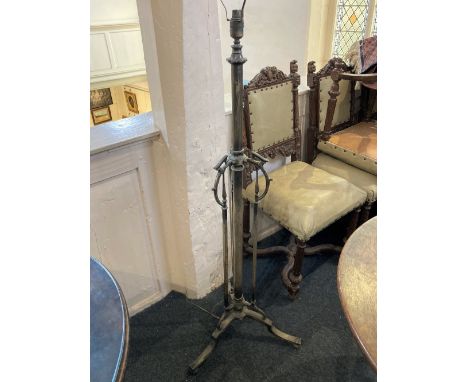 An early 20th century brass standard lamp single column with three scroll supports and tripod base, 125cm high