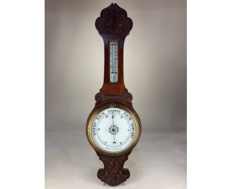 A carved mahogany banjo aneroid barometer, 83cm