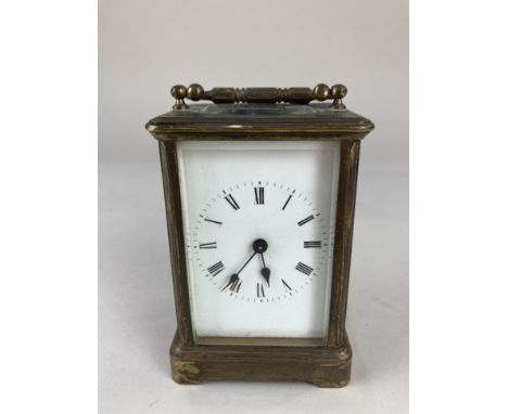 A brass and bevelled glass cased carriage clock, 14.5cm high