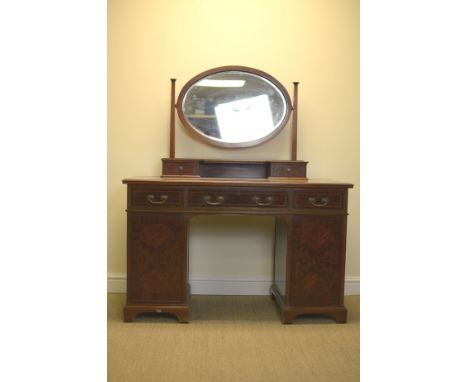 A Waring and Gillow Ltd mahogany Dressing Table with oval mirror, fitted three frieze drawers above pair of doors, further pa