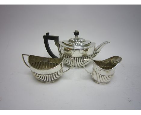 A Victorian silver three piece Tea Service of oval semi-fluted form, Sheffield 1893