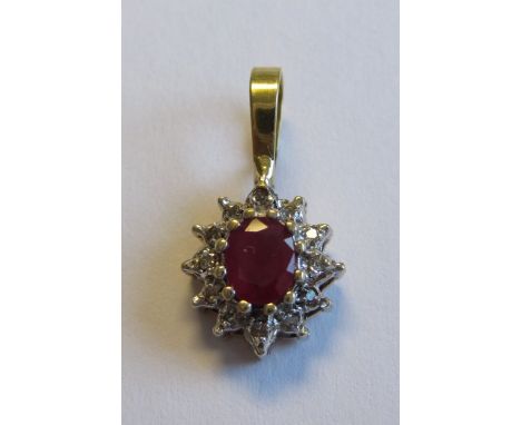 A Ruby and Diamond Pendant claw-set oval-cut ruby within twelve diamonds in 14ct gold