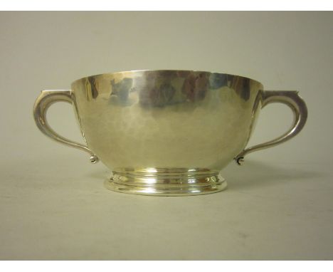 A George V silver heavy two handled circular Bowl with hammered design, Birmingham 1927, maker: Adie Bros