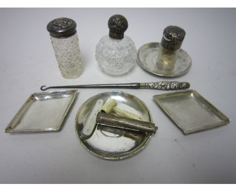 Pair of silver lozenge shaped Trinket Dishes, pair of coin inset silver Ashtrays, a silver lidded cut glass Scent Bottle, Cig