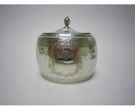 A Victorian silver oval Tea Caddy with engraved frieze and vacant shield shape cartouche, London 1897