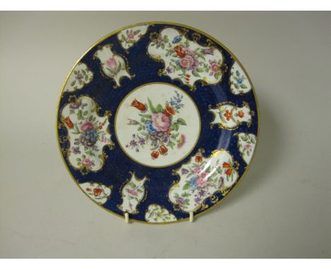 A Barr Flight and Barr Worcester Plate with floral reserves having gilt borders on scale blue ground, 9 1/4in