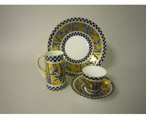 A Coalport part Tea Service with blue and gilt bird and bamboo pattern, viz: 12 Cups and Saucers, 7 Plates, Jug, Sugar Bowl a