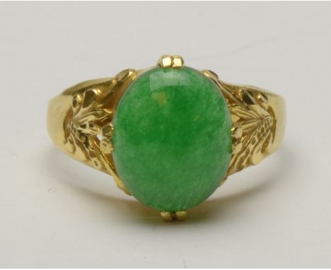 A Jade Ring claw-set oval cabochon in pierced leafage mount, stamped 750, ring size P 1/2