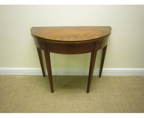 A Georgian mahogany Card Table with semi-circular cross-banded fold-over top on square tapering legs, 3ft W