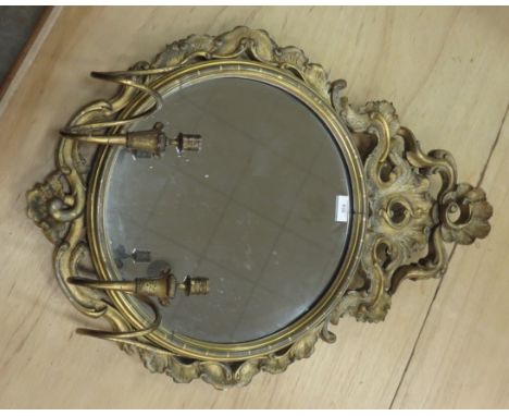 An early 19th Century gilt circular Wall Mirror with pierced and scrolled surmount and two candle sconces, 2ft 9in H