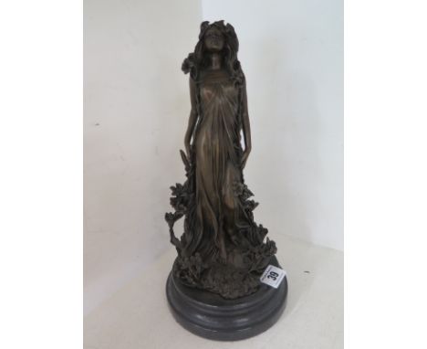 A modern bronze figure of a young lady on a marble base