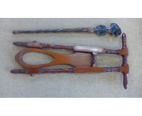 A mahogany Victorian boot jack and an African walking stick 