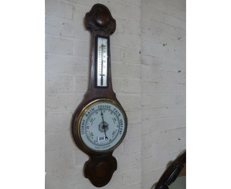 An oak cased aneroid barometer with white enamelled dial