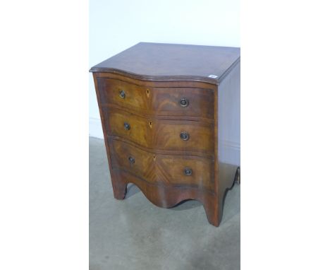 A mahogany and crossbanded three drawer serpentine chest of drawers on bracket feet - Width 60cm x Height 74cm