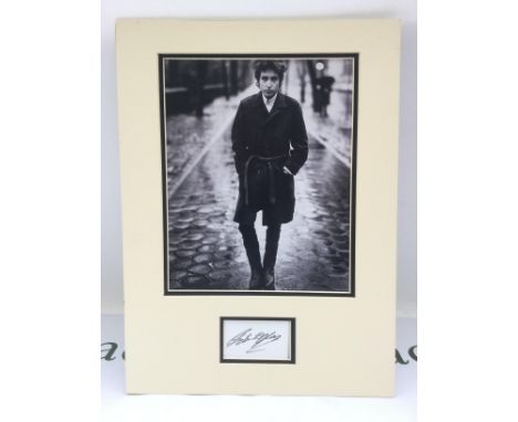 A Bob Dylan signed photo display. No COA. Please note that we are not experts in this field and can offer no guarantees that 