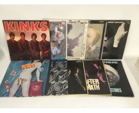 Two bags containing 20 rock LPs by various artists including David Bowie, The Rolling Stones, Queen and others. Includes a ye
