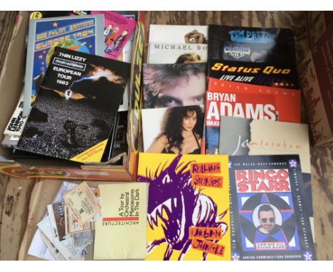 A box of concert programmes, tickets, books and calendars for various artists including The Rolling Stones, Bryan Adams, OMD 