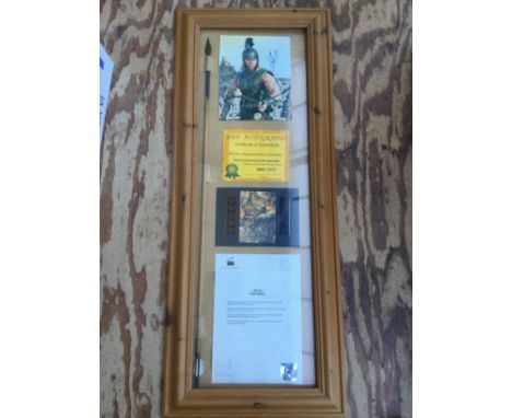 A Troy movie display containing a screen used prop arrow and signed Brad Pitt photo.