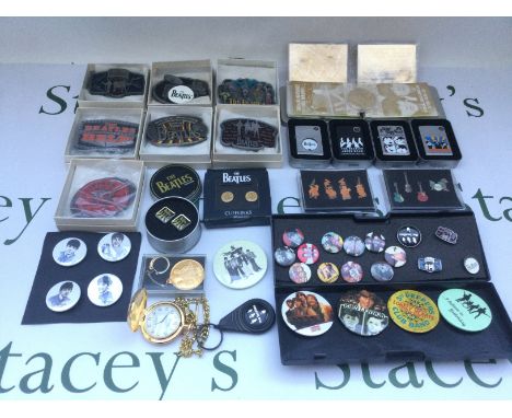 A collection of Beatles memorabilia comprising two 23kt gold trading cards, four zippo lighters, various badges, belt buckles