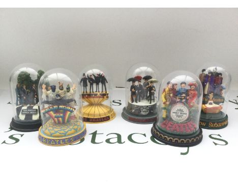 Six Franklin Mint limited edition Beatles figural groups under glass domes, approx height 12cm.