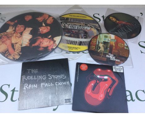 A box of Rolling Stones picture discs, CDs, DVDs and VHS tapes.