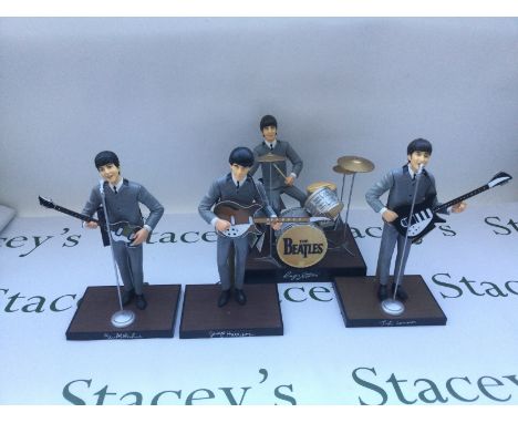 A complete set of Beatles figurines by Hamilton Gifts, with original tags.