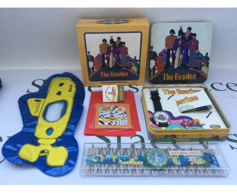 A cased Beatles Swatch watch and a cased Yellow Submarine fossil watch (2).
