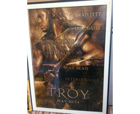 A signed US one sheet film poster for the 2004 movie Troy, signed by Brad Pitt and Orlando Bloom. Framed and glazed, not fold