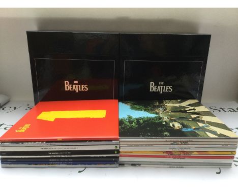 A complete Beatles DeAgostini 180g LP collection with inserts, a USB power bank and a boxed Beatles zippo lighter.