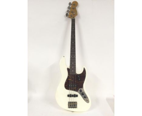 A Fender Squier Jazz bass guitar in white with a tortoishell pickguard. Comes supplied with a hard carry case.