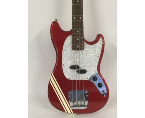 A Fender Mustang Bass guitar in a dakota red competition finish, made in Japan.
