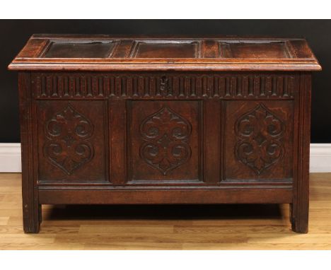 A late 17th/early 18th century oak three panel blanket chest, of small proportions, hinged cover, nulled frieze, the front ca