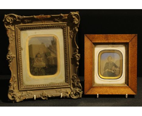 Photography - a 19th century tinted and backed ambrotype photograph, of a young lady, seated, holding a letter, maple frame; 