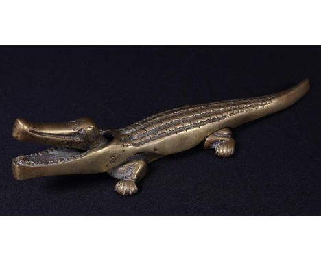 A brass novelty lever-action table-top nutcracker, as a crocodile, 36cm long, mid-20th century 