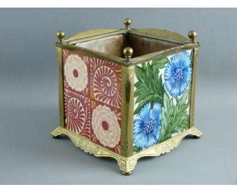 FOUR EARLY WILLIAM DE MORGAN POTTERY TILES housed in a square brass planter frame with ball finials, splayed foot and open ca