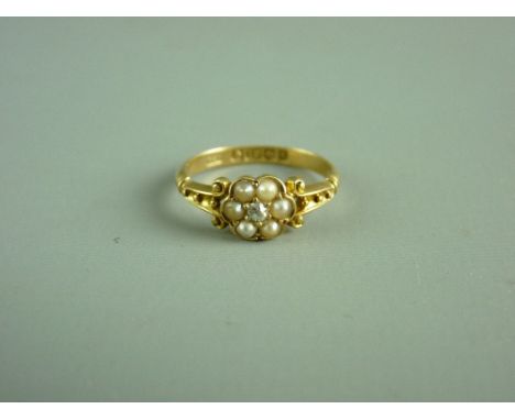 AN EIGHTEEN CARAT GOLD DRESS RING with centre tiny diamond and five surrounding seed pearls, 2.6 grms, size 'K'