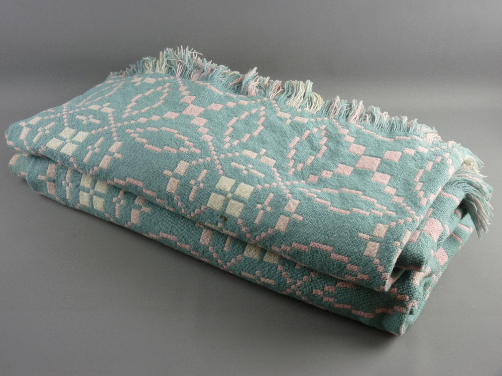 A LARGE VINTAGE WELSH WOOLLEN BLANKET in pink and green tones with