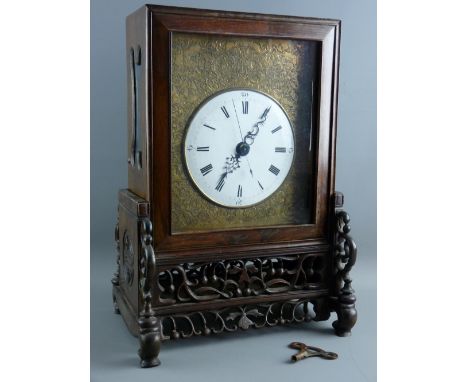 A CHINESE TWIN FUSEE TABLE CLOCK ON STAND, the 17 cms diameter white enamel dial set with Roman numerals and Arabic sweep sec