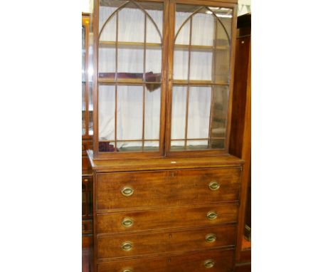 A GEORGE IV MAHOGANY BOOKCASE CHEST, the two door glazed top with eleven pane doors with arched moulding and adjustable inter