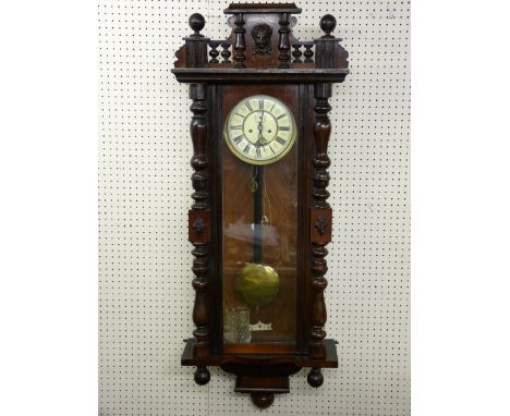 A WALNUT CASED VIENNA STYLE WALL CLOCK, twin weight pendulum driven movement striking on a coiled gong, the dial set with Rom