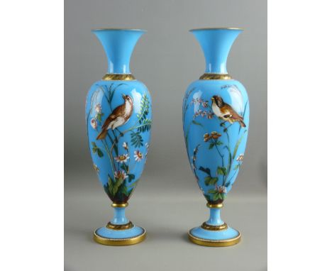 A PAIR OF VICTORIAN BLUE OPAQUE GLASS ENAMEL PAINTED BALUSTER VASES having opposing birds amongst grasses and wild flowers an