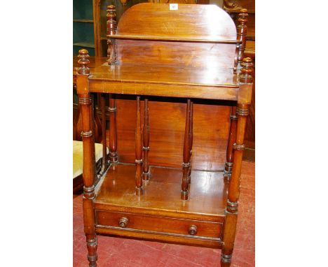 A VICTORIAN MAHOGANY WHATNOT CANTERBURY having a shelved back rail, a three sectional base shelf with drawer below all on tur