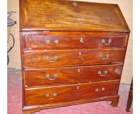 A GEORGIAN MAHOGANY FALL FRONT BUREAU having four long lower drawers on corner bracket feet, the fall interior with an arrang