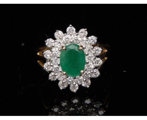 A new emerald and diamond cluster ring, central oval emerald, approx 1.08ct, surrounded by a twenty eight stone pave diamond 