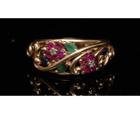 A diamond ruby emerald and sapphire open work floral ring, the open twin flower head crest encrusted with two round brilliant