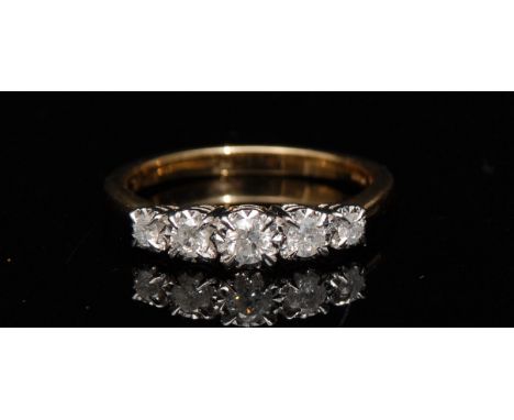 A new five stone diamond ring, central round brilliant cut diamond, raised above stepped shoulders set with four smaller grad