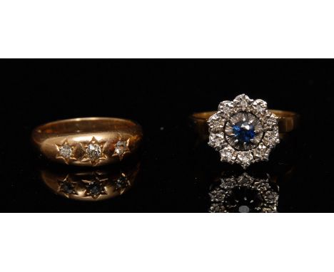 A sapphire and diamond cluster ring, central round blue sapphire, surrounded by a band of ten illusion set diamond accents, 9